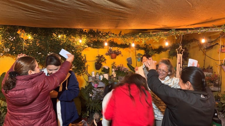 Group of people in winter clothing decorating a golden tent with garland and lights during festive celebration