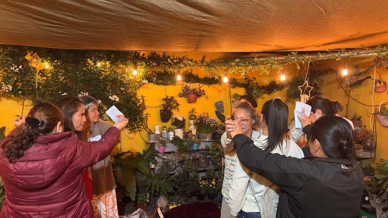 Group of people celebrating indoors under warm lighting and decorative greenery, raising glasses in a toast